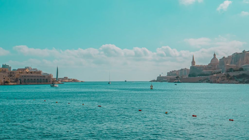 Tranquil seascape showcasing Maltas stunning historic harbor with vibrant blue waters.